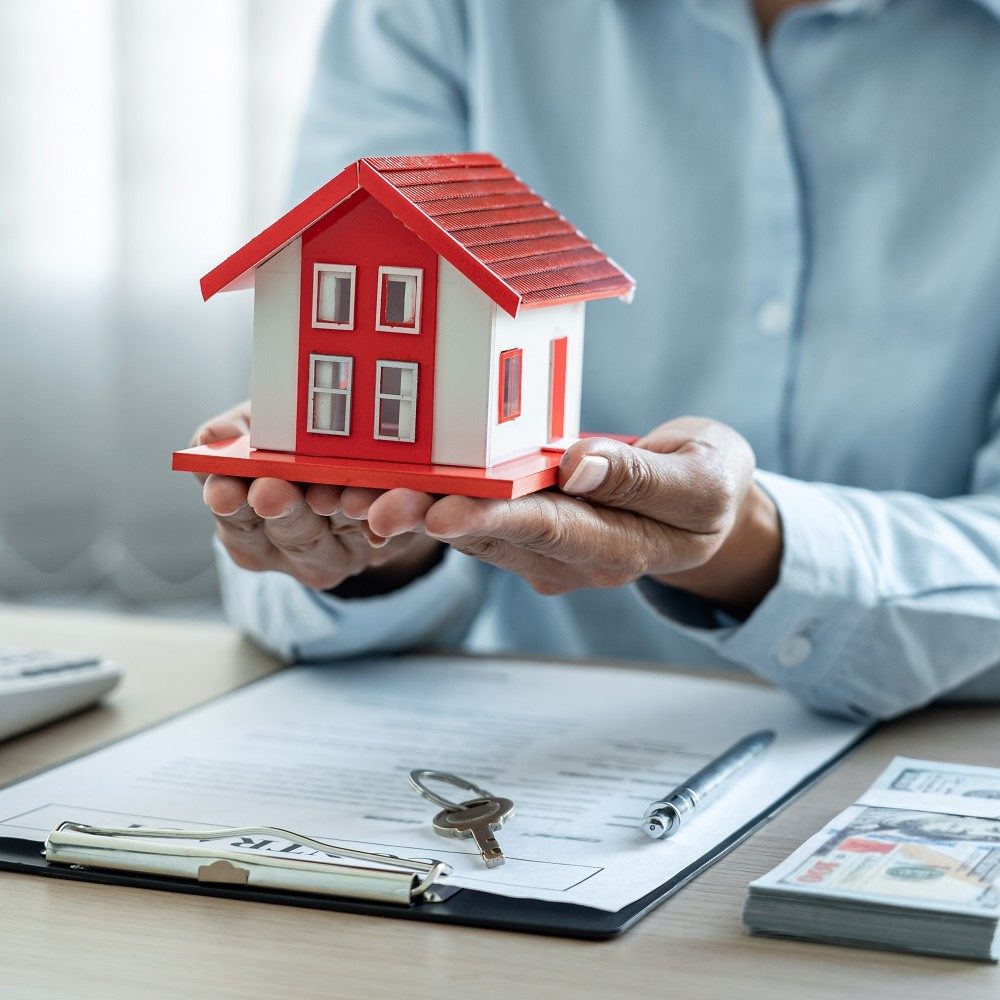 female-real-estate-agent-is-use-hands-holding-hous-2022-11-15-15-40-29-utc (1)
